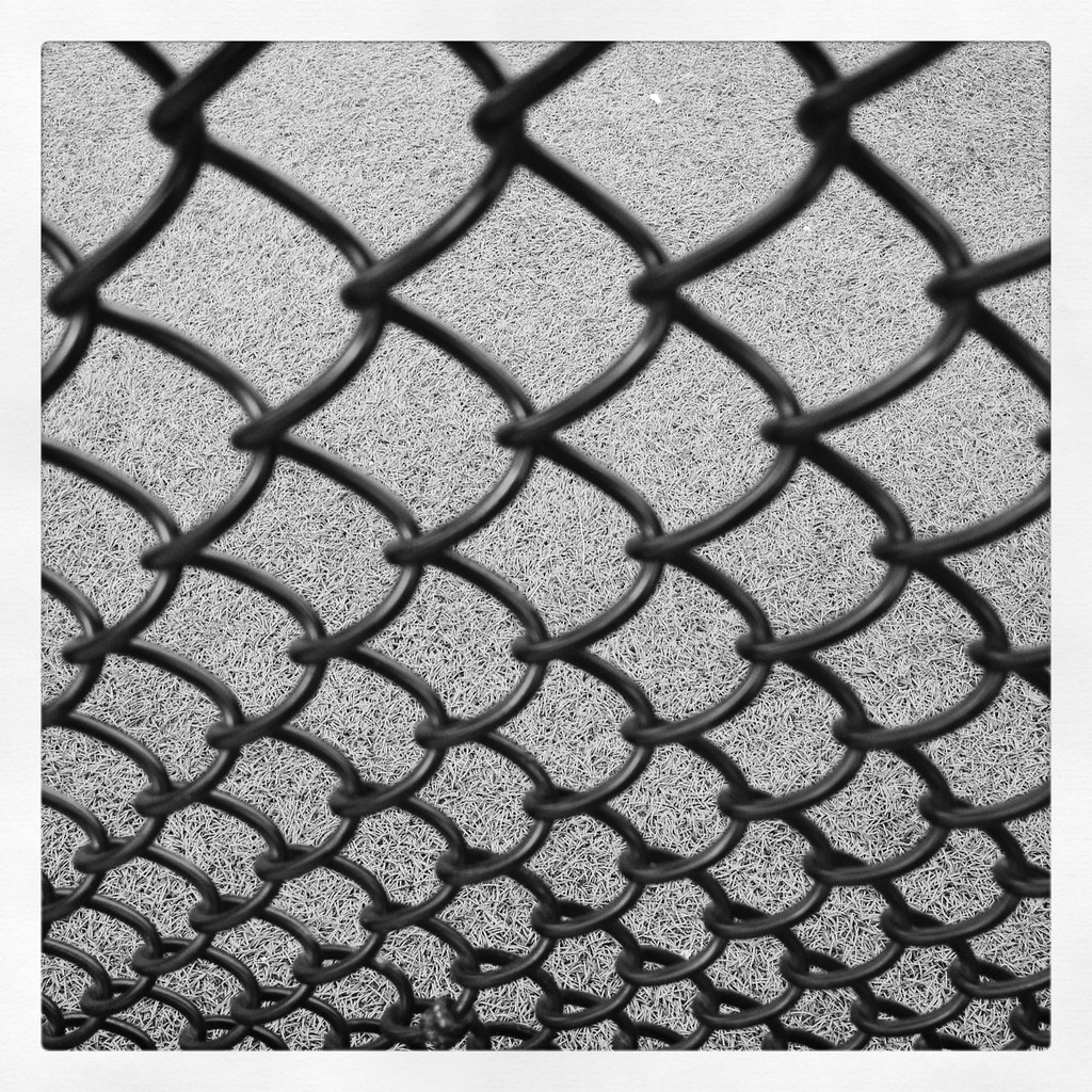 Close-up of black chain-link wire mesh fencing